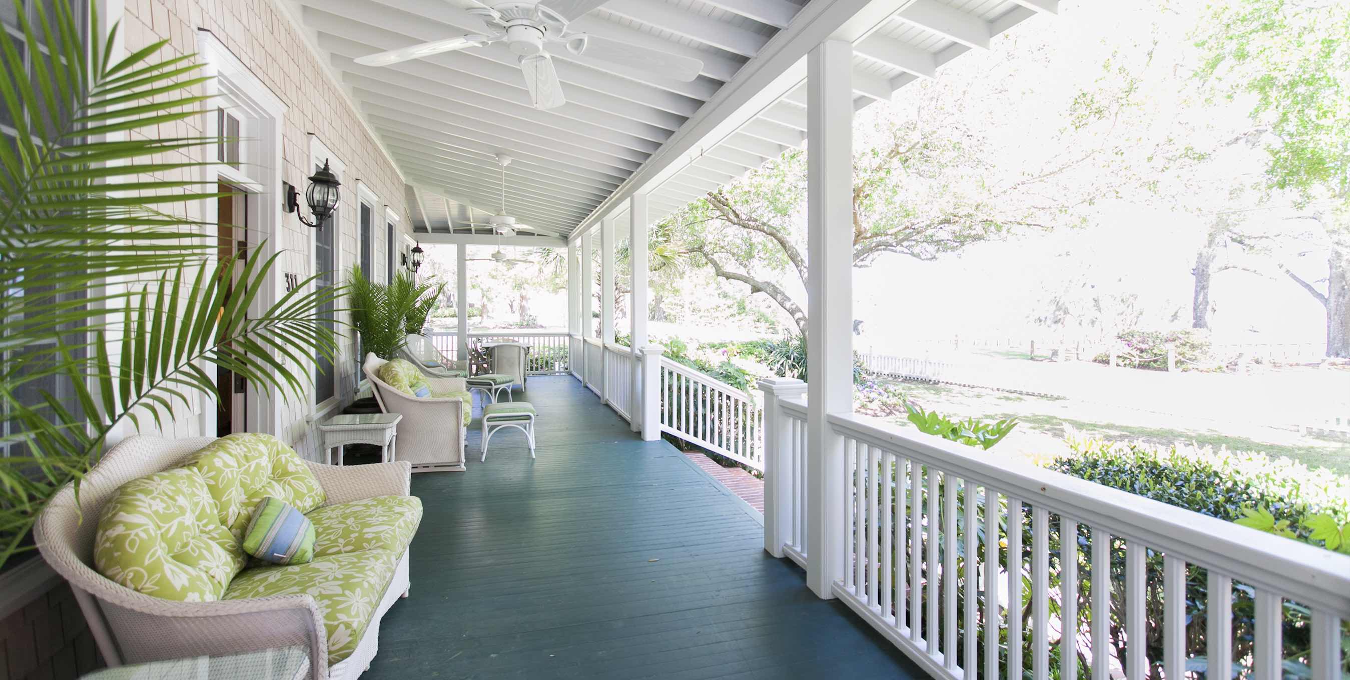 Picture of house with plants and seats on front porch to represent the sub-title Enhance Your Front Entrance