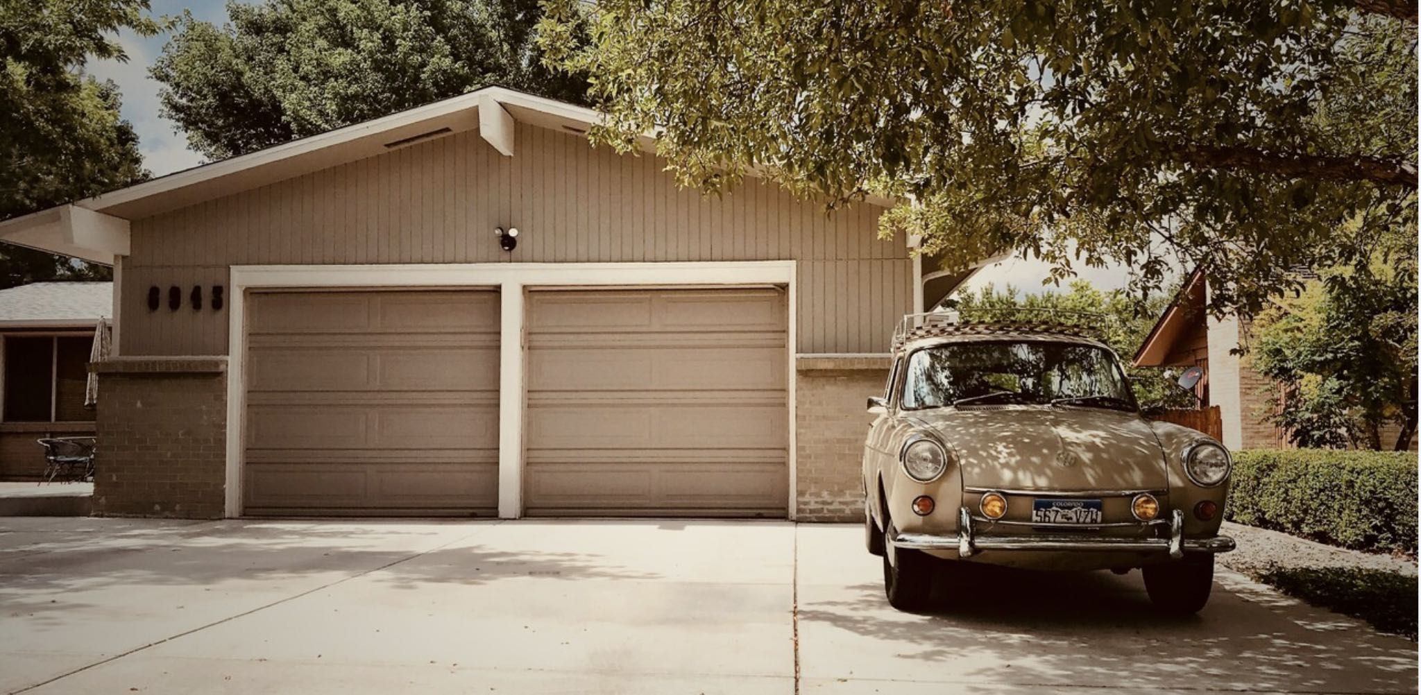 Picture of a driveway featuring a retro car to represent the sub-title replace your garage door