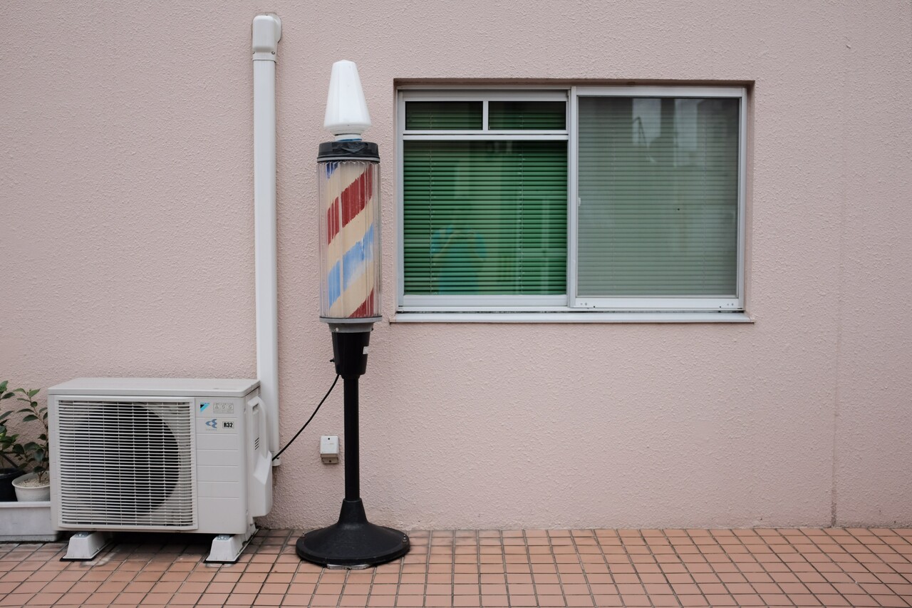 Image of air conditioner fan unit outside.