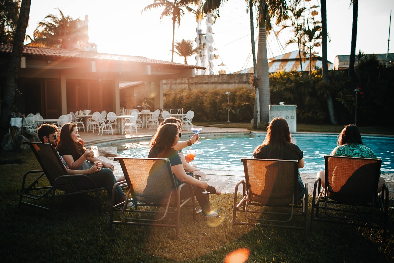 A group of friends hanging out by a pool.