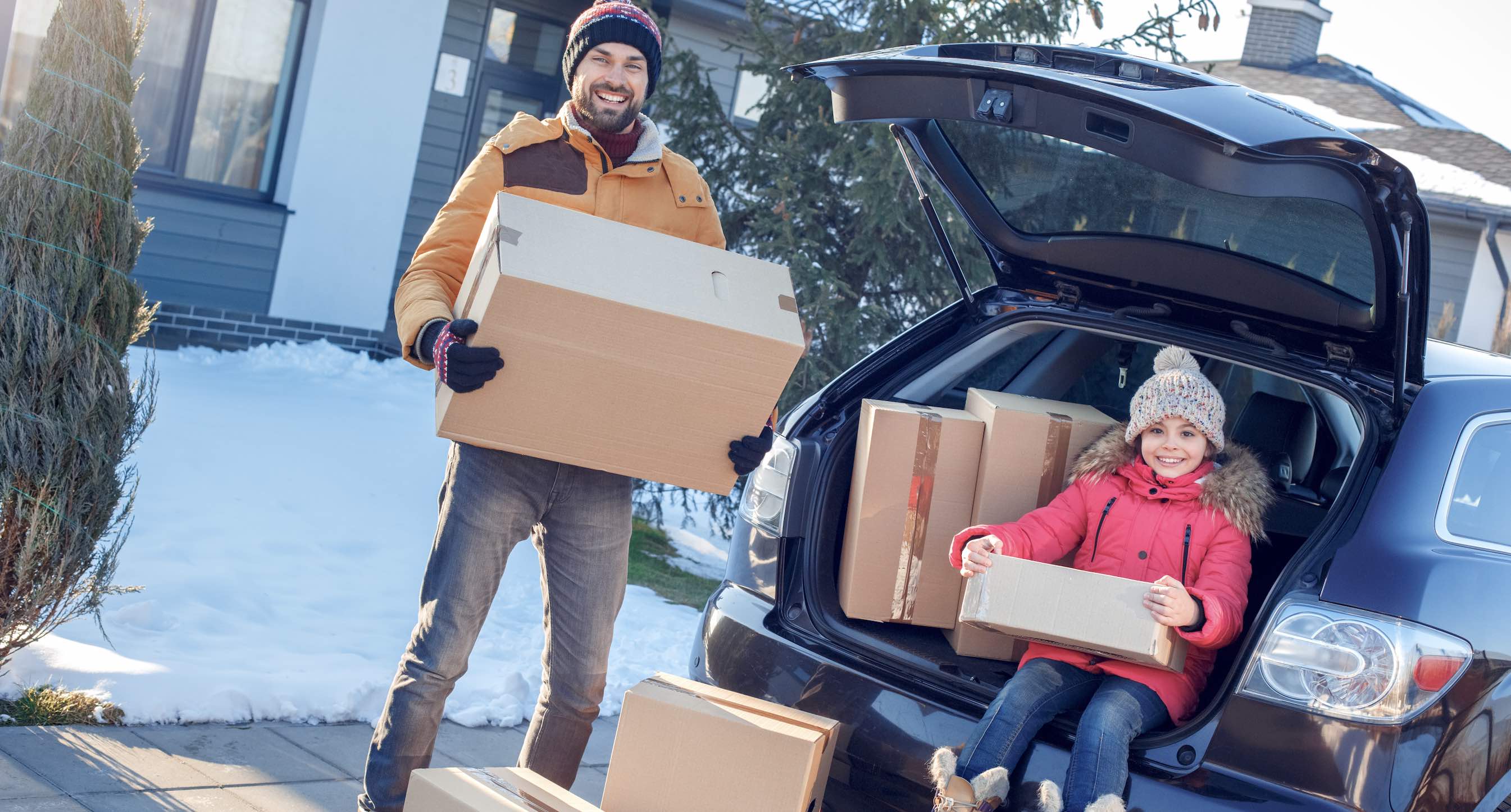 Photo of family moving into a new house in winter.