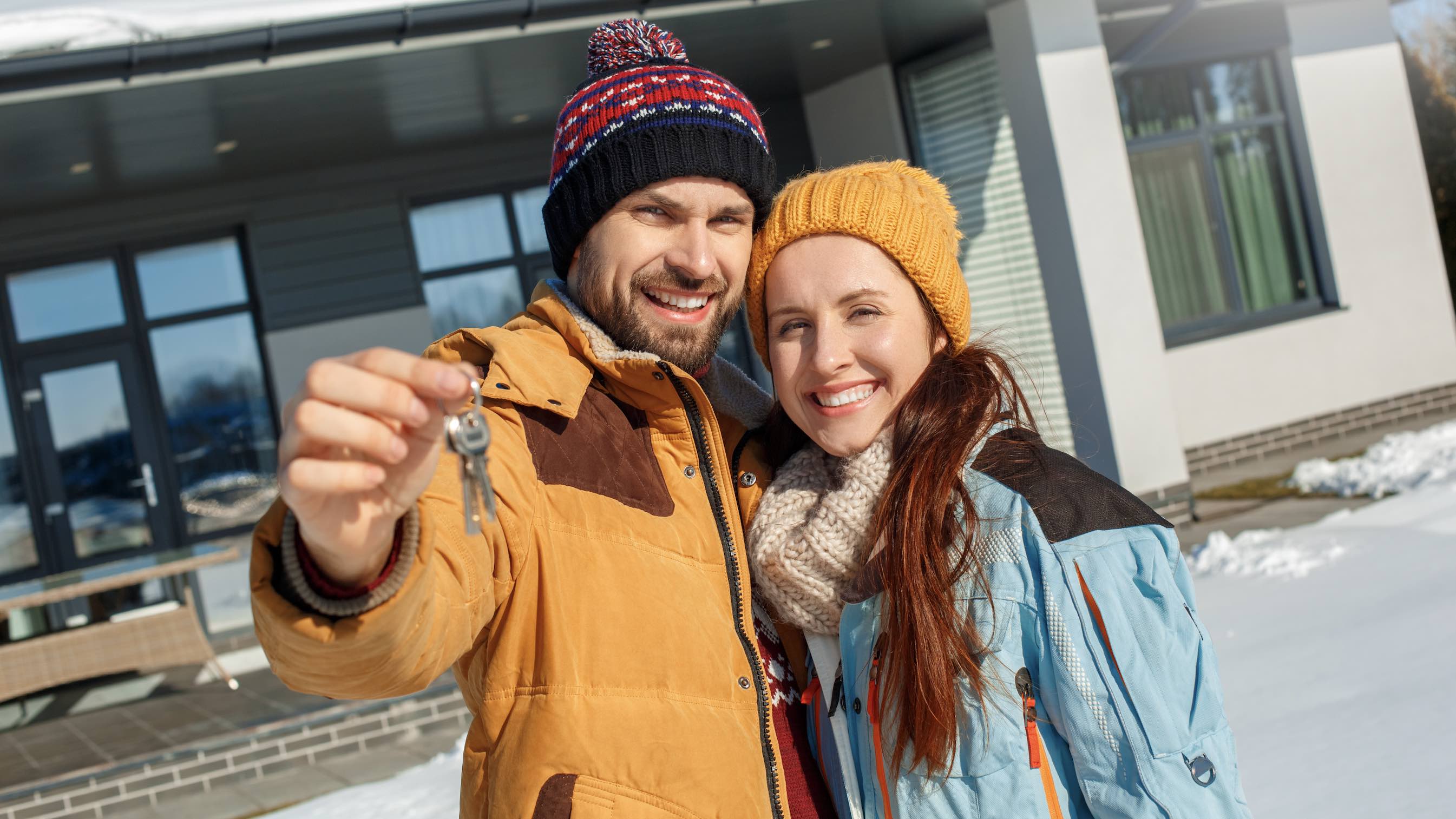 Photo of family who got the keys to a new house in winter.