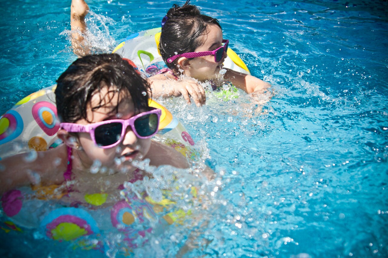 Children swimming in a pool.
